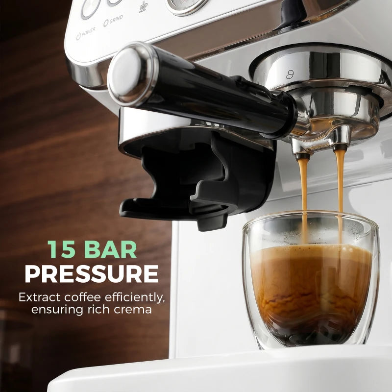Close-up of steam wand pouring espresso into a glass cup on white machine