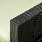 Close-up of black woven wicker armrest with cream cushion on outdoor lounger