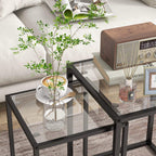 Rectangular black nesting table with clear tempered glass top and open steel frame