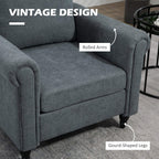 Grey upholstered chair close-up showing rolled arms and front seat cushion