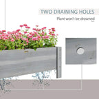 Grey raised garden bed planter with visible drainage holes
