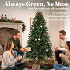 Green artificial Christmas tree decorated with ornaments and garland, on wooden stand