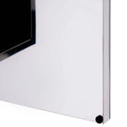Silver cabinet corner and bottom edge of wall-mounted mirror storage unit