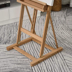 Natural wood H-frame easel standing on a base with locking hardware