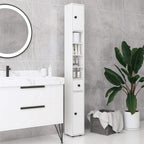 White slim bathroom storage tower cabinet with shelves and drawers, black knobs.