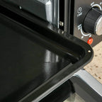 Black oven door latch area with power indicator and control dial on front panel