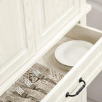 White pull-out drawer with stacked plates and cutlery organizer; black drawer handles