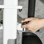 Hand adjusting a stair stepper pedal height knob on the base.