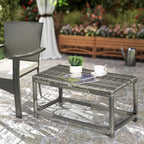 Grey rectangular outdoor side table with woven top and lower shelf, metal frame