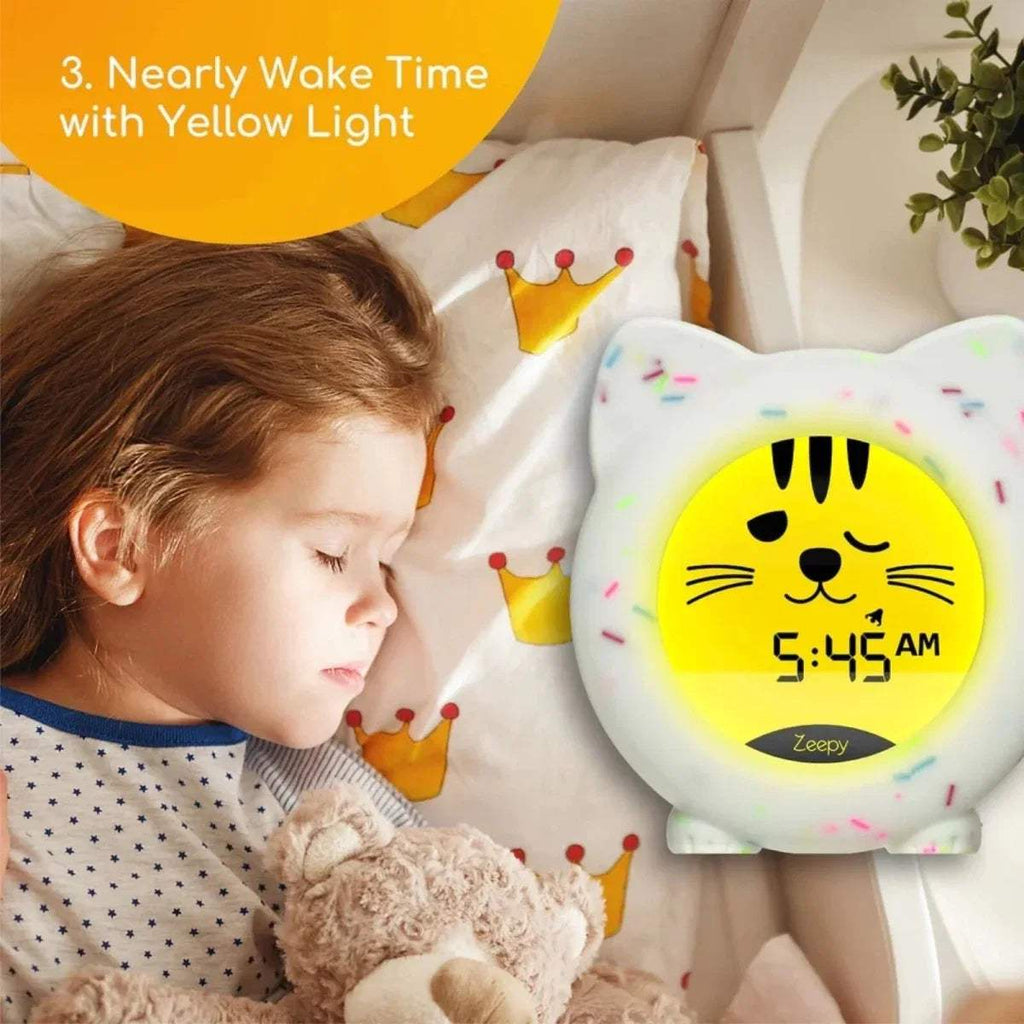 White cat-shaped sleep clock with bright yellow glow time screen and striped whiskers