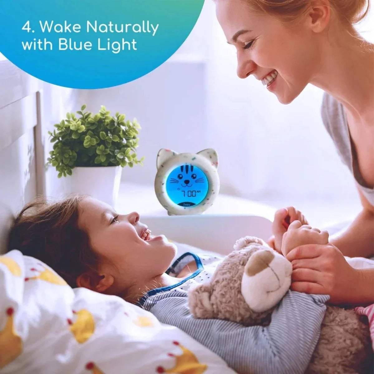 Cat sleep trainer clock with blue light display and cute face on speckled white body