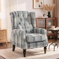 Plaid wingback armchair with tufted back, cushioned seat, and dark tapered legs