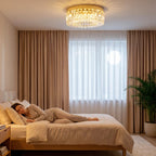 Gold-tone flush crystal chandelier with clear hanging prisms and warm glow