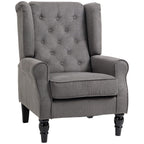 Dark grey wingback armchair with button-tufted back, rolled arms, and fabric upholstery