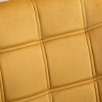 Yellow velvet accent chair back with quilted square padding and stitched seams