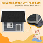 Grey wooden cat house raised on feet, with arched door and front window