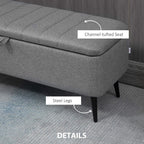Grey upholstered storage ottoman with channel-tufted seat and steel legs
