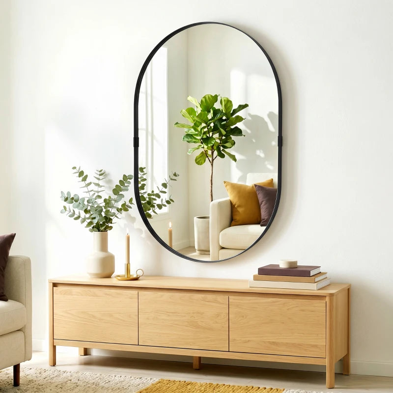 Black oval wall mirror with thin frame and clear reflective glass