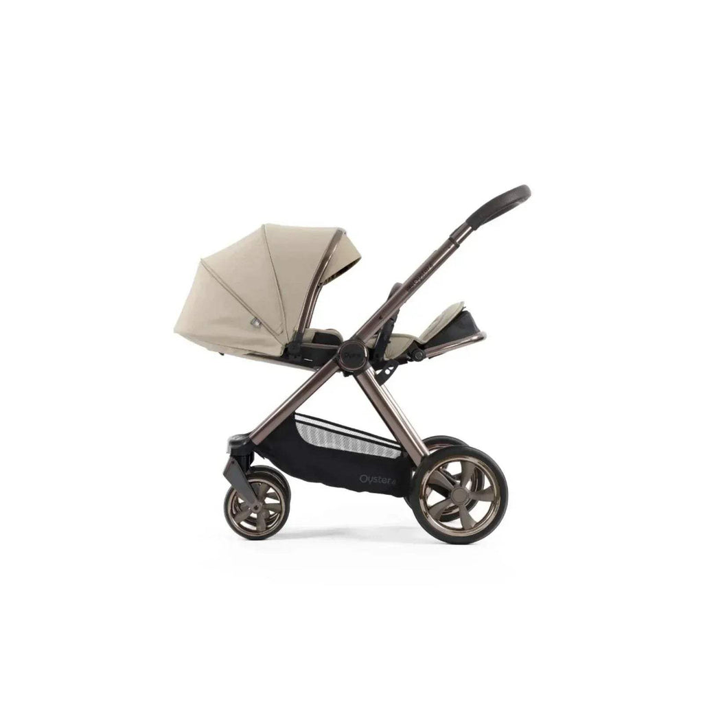 Buttermilk stroller with canopy, black frame, angled side view with wheels visible