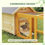 Natural wood duck house attached to a mesh run with front door access
