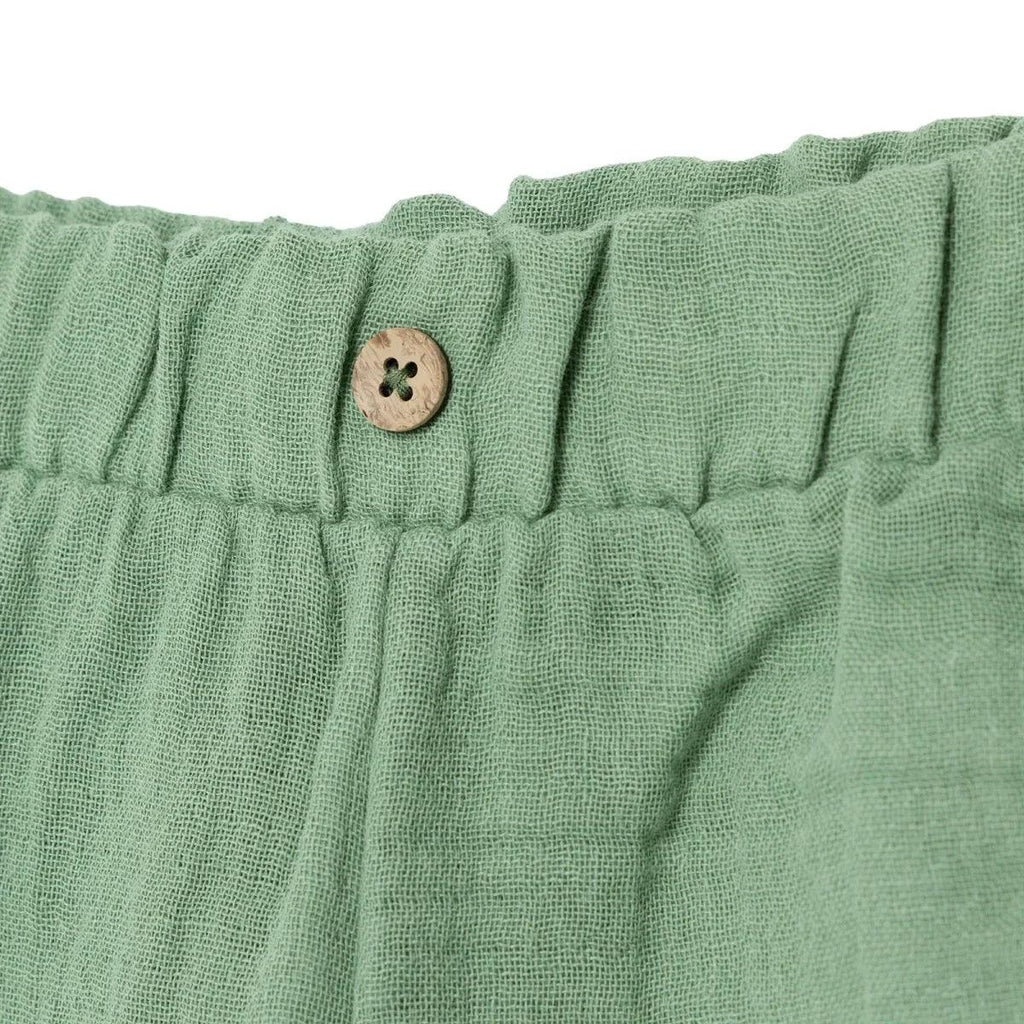 Green muslin baby shorts waistband detail with button at center