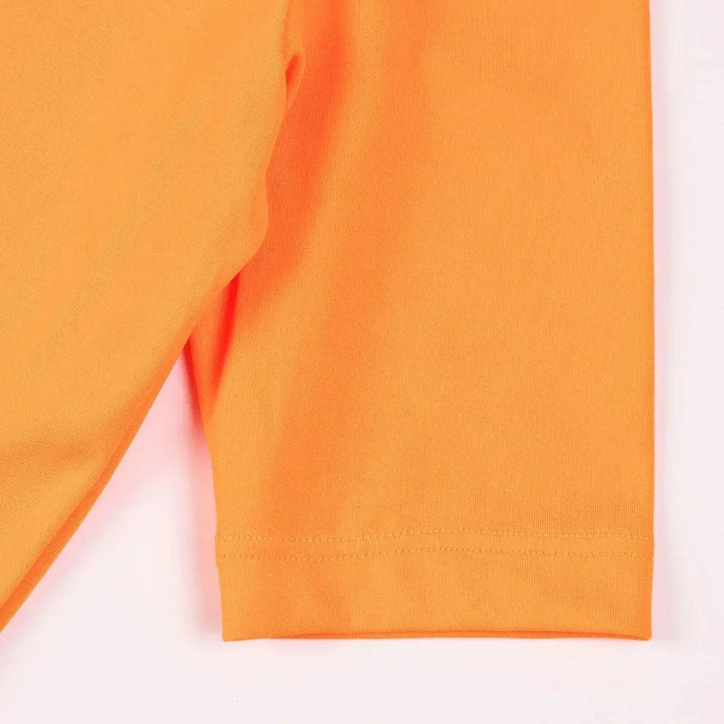 Neon orange swim top hem with stitched bottom edge, short sleeve.