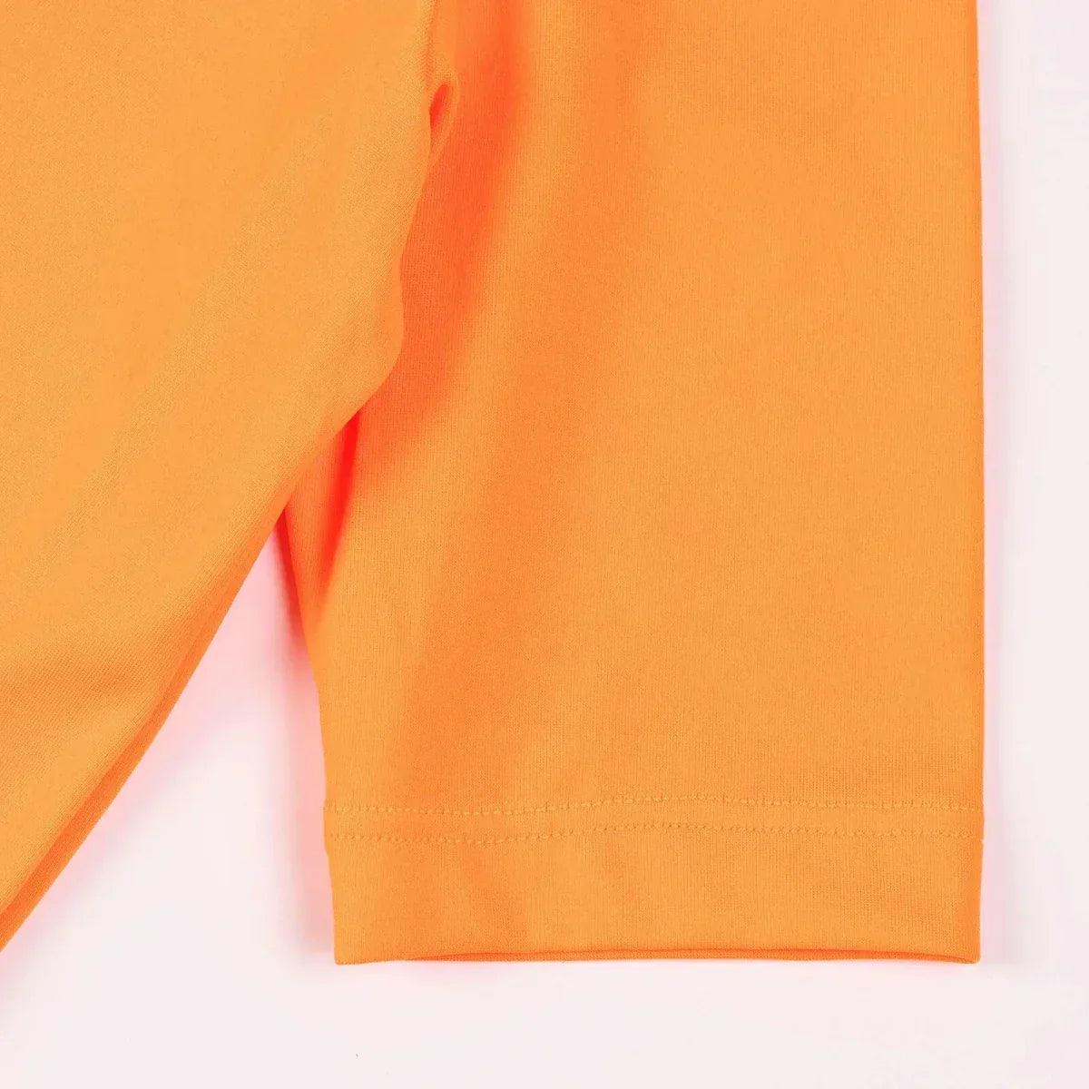 Neon orange swim top hem with stitched bottom edge, short sleeve.