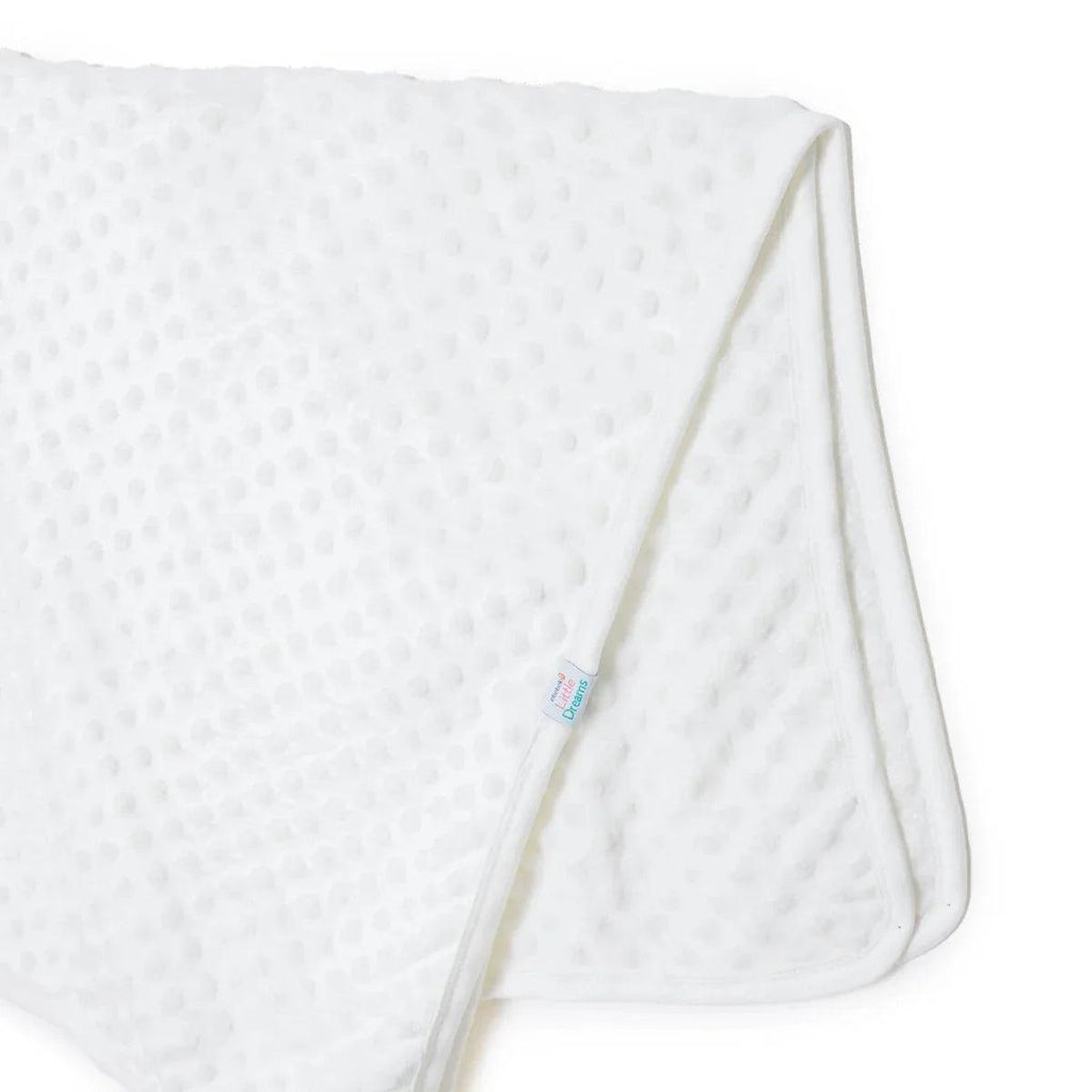 Ecru fleece baby blanket corner with “Little Dreams” label and stitched edge seam