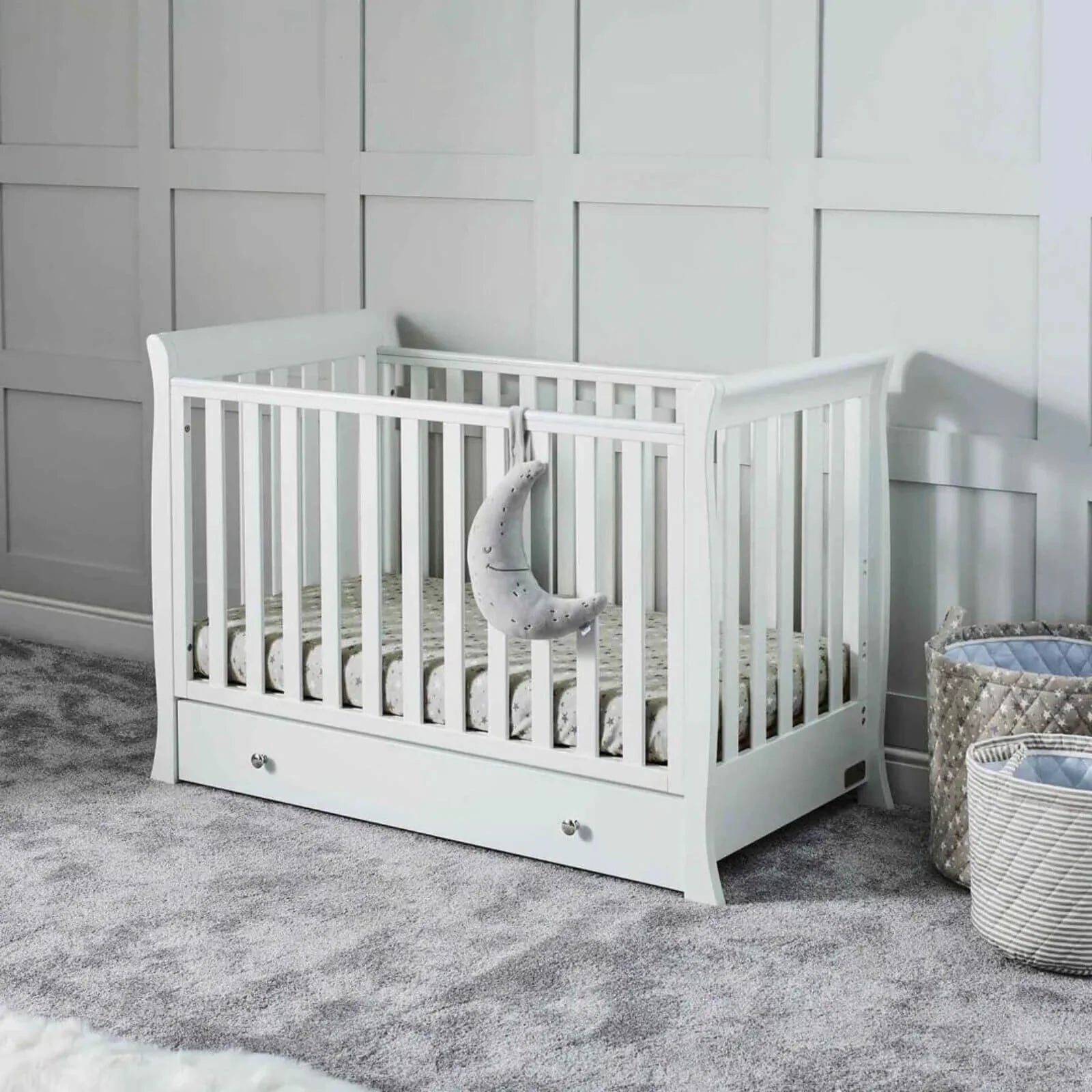 White mini cot bed with slatted sides and storage drawer, set with mattress