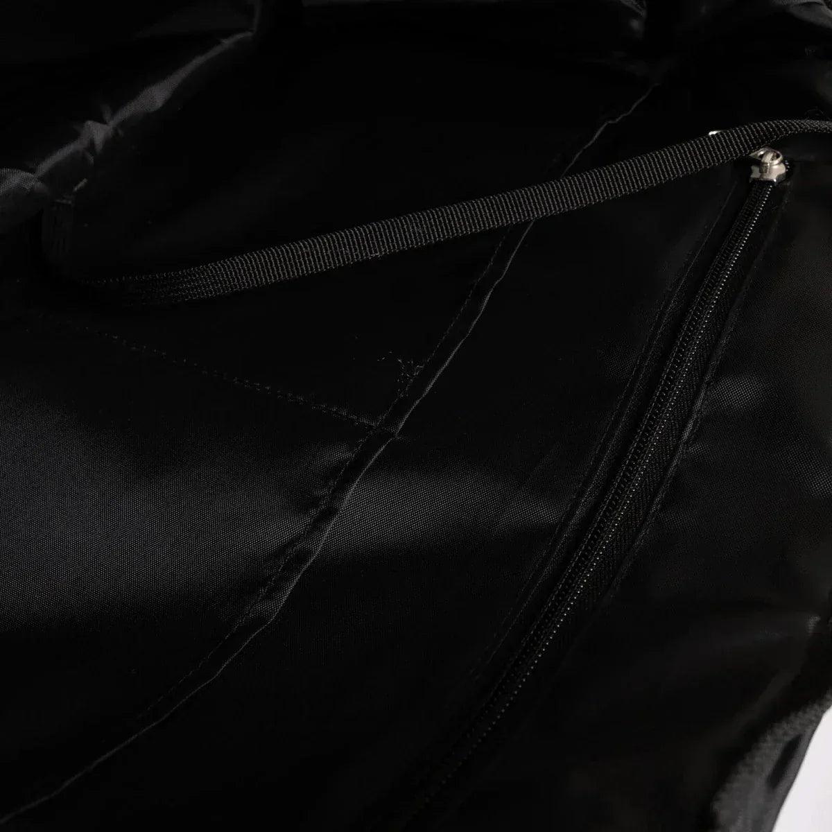 Black quilted shoulder bag close-up of inner seam and zipper track