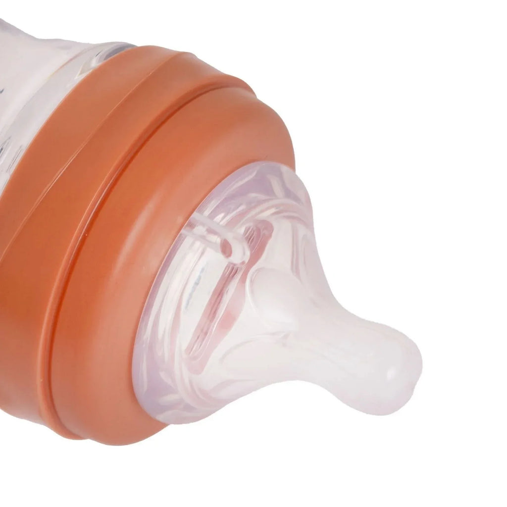 Close-up of coral pink fast-flow nipple on clear Tritan Neutra feeding bottle
