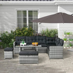 Grey rattan L-shaped patio sofa set with black cushions, glass coffee table, footstools