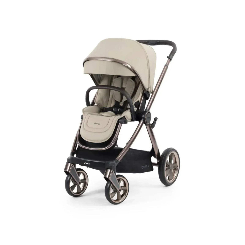 Buttermilk stroller with beige canopy and seat, black frame, front three-quarter view