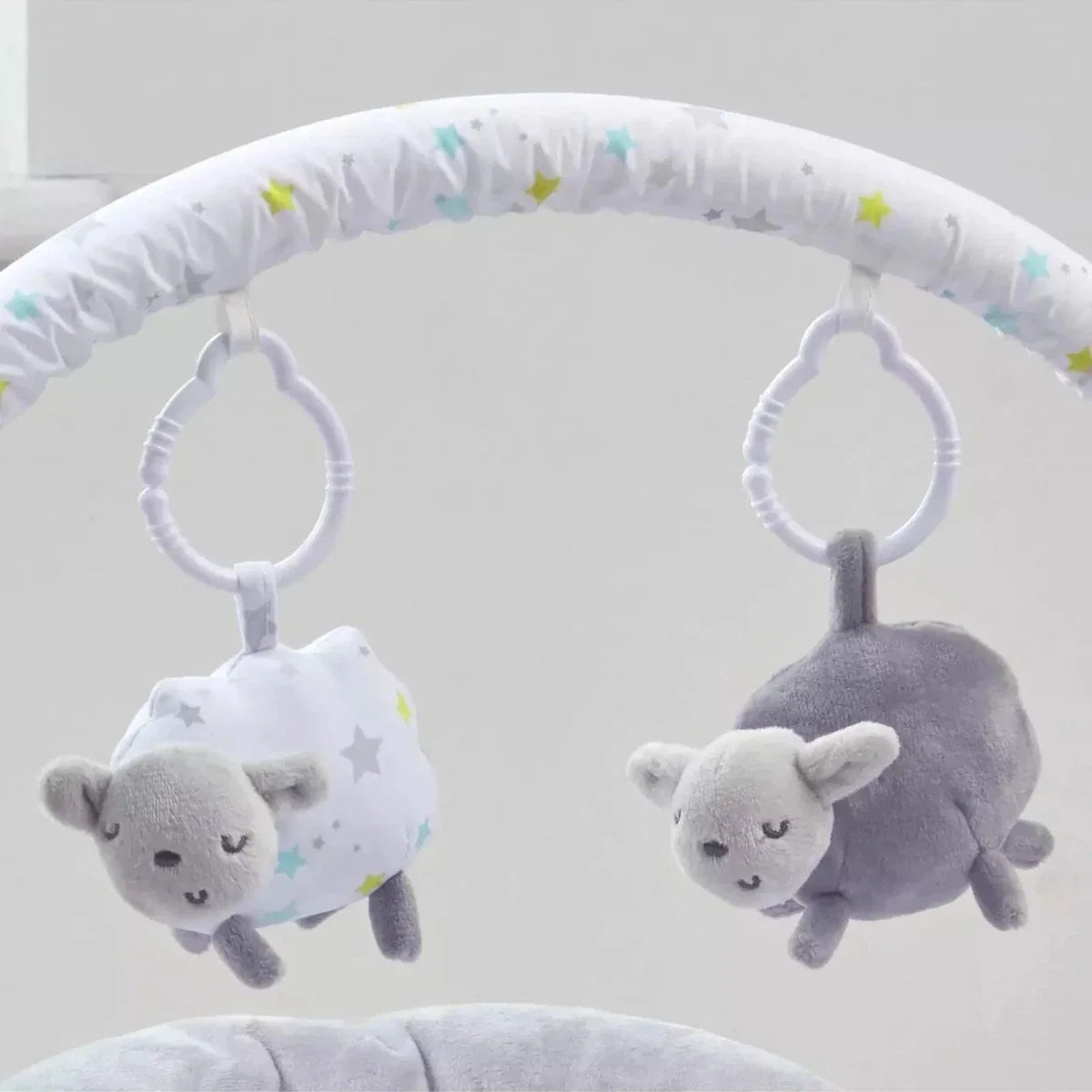 Baby bouncer arch with hanging plush sheep toys in white and grey