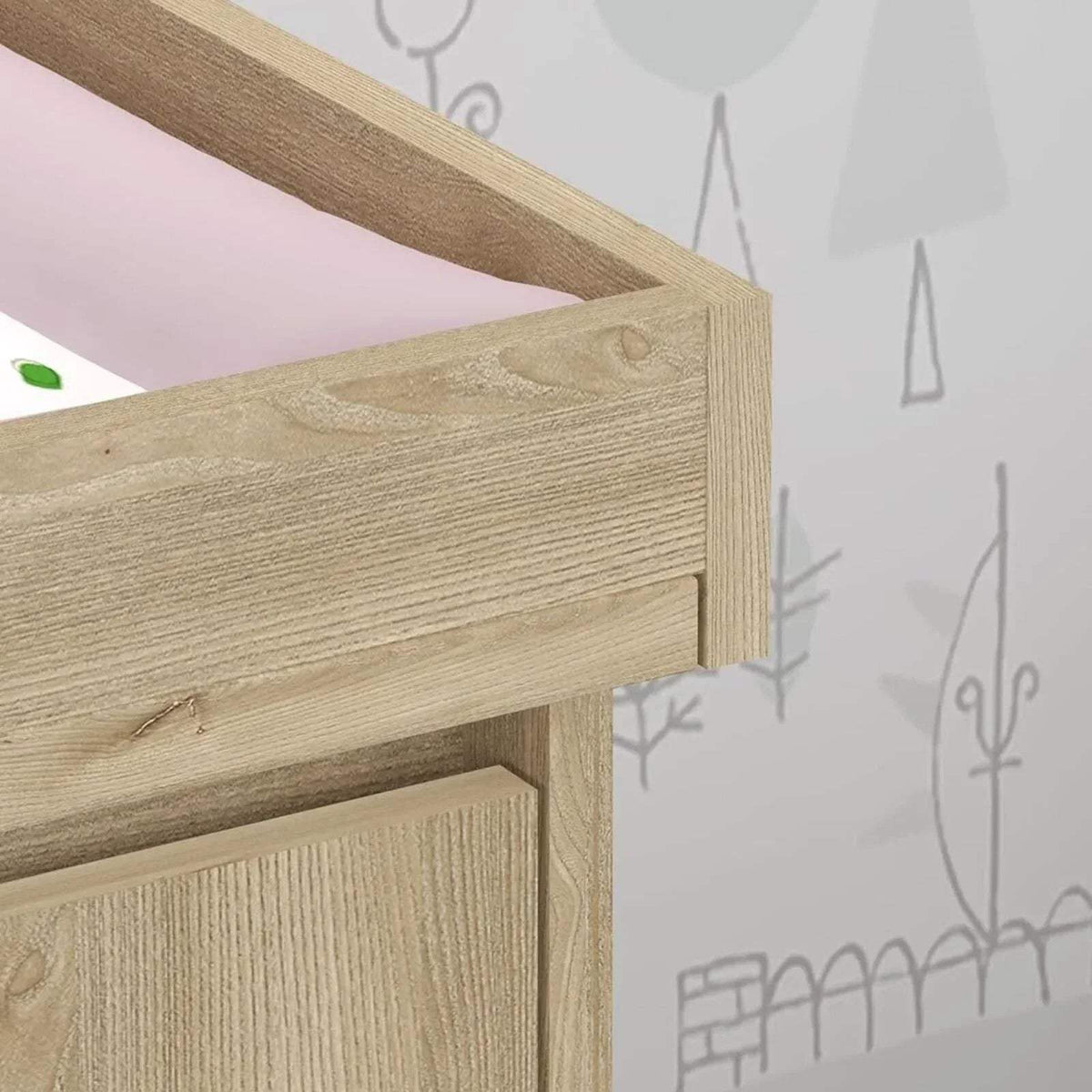 Light oak changing unit corner with visible wood grain and horizontal rail