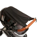 Black stroller sunshade with fabric canopy and side tie straps for stroller mounting