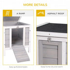 Grey wooden hutch featuring a ramp and asphalt-style roof for covered shelter