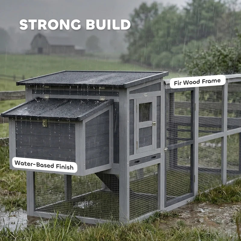 Grey wooden chicken coop with wire mesh run, double doors, and asphalt roof