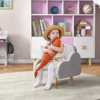 Grey kids armchair with armrests and light wood legs, child seated