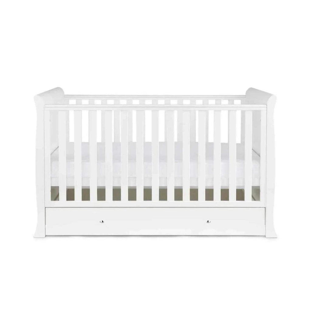 White cot bed front view with vertical slat rails and drawer panel, without mattress.