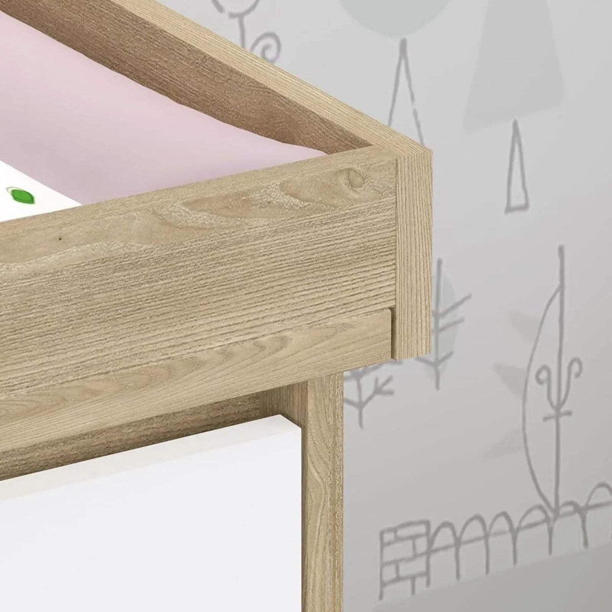 Light oak wood frame corner with white drawer panel and visible grain texture