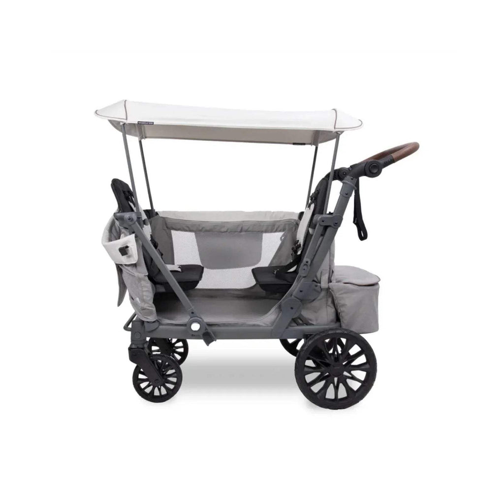 Grey stroller wagon, side view with canopy, 4 wheels and safety straps.