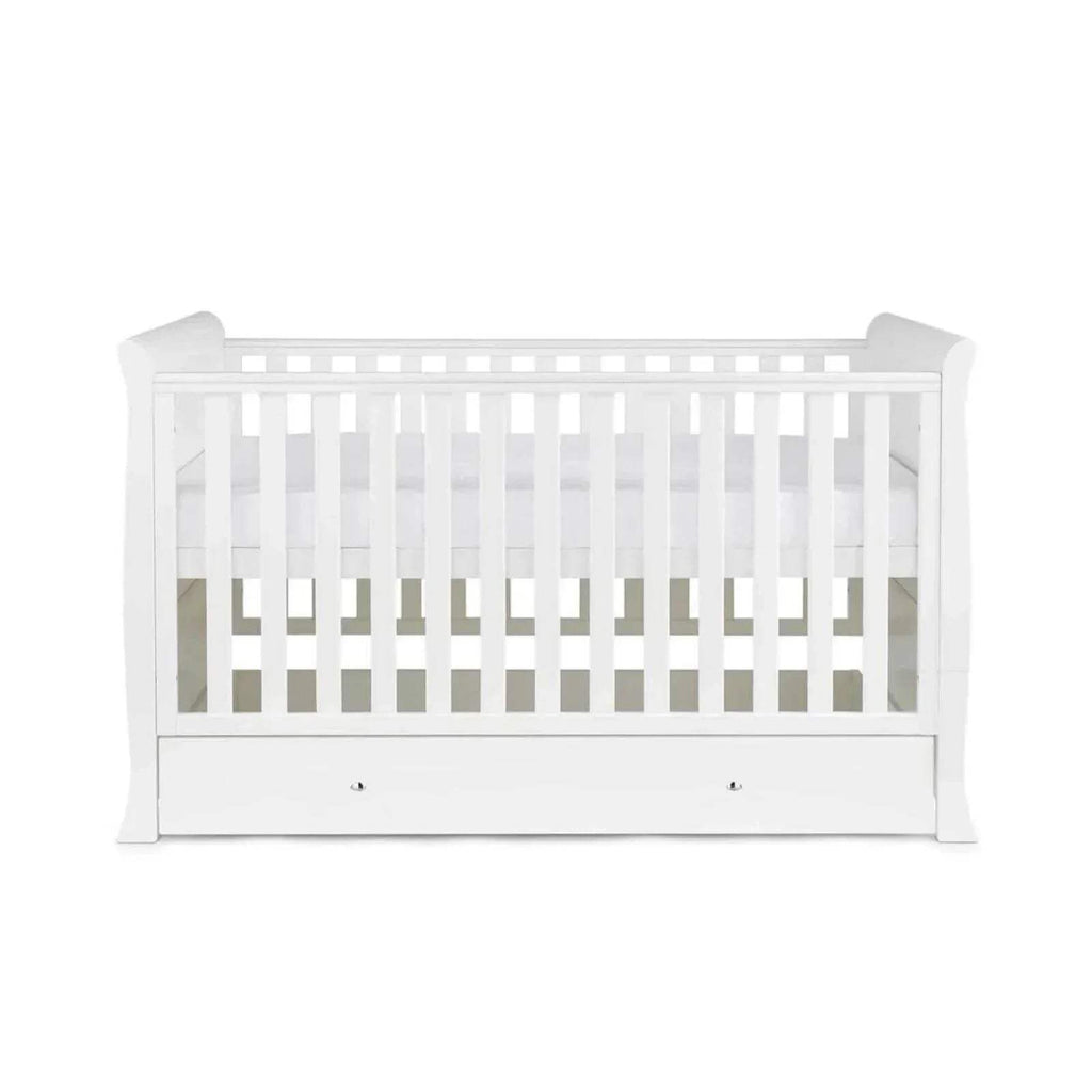 White baby cot view with vertical slats and drawer storage panel