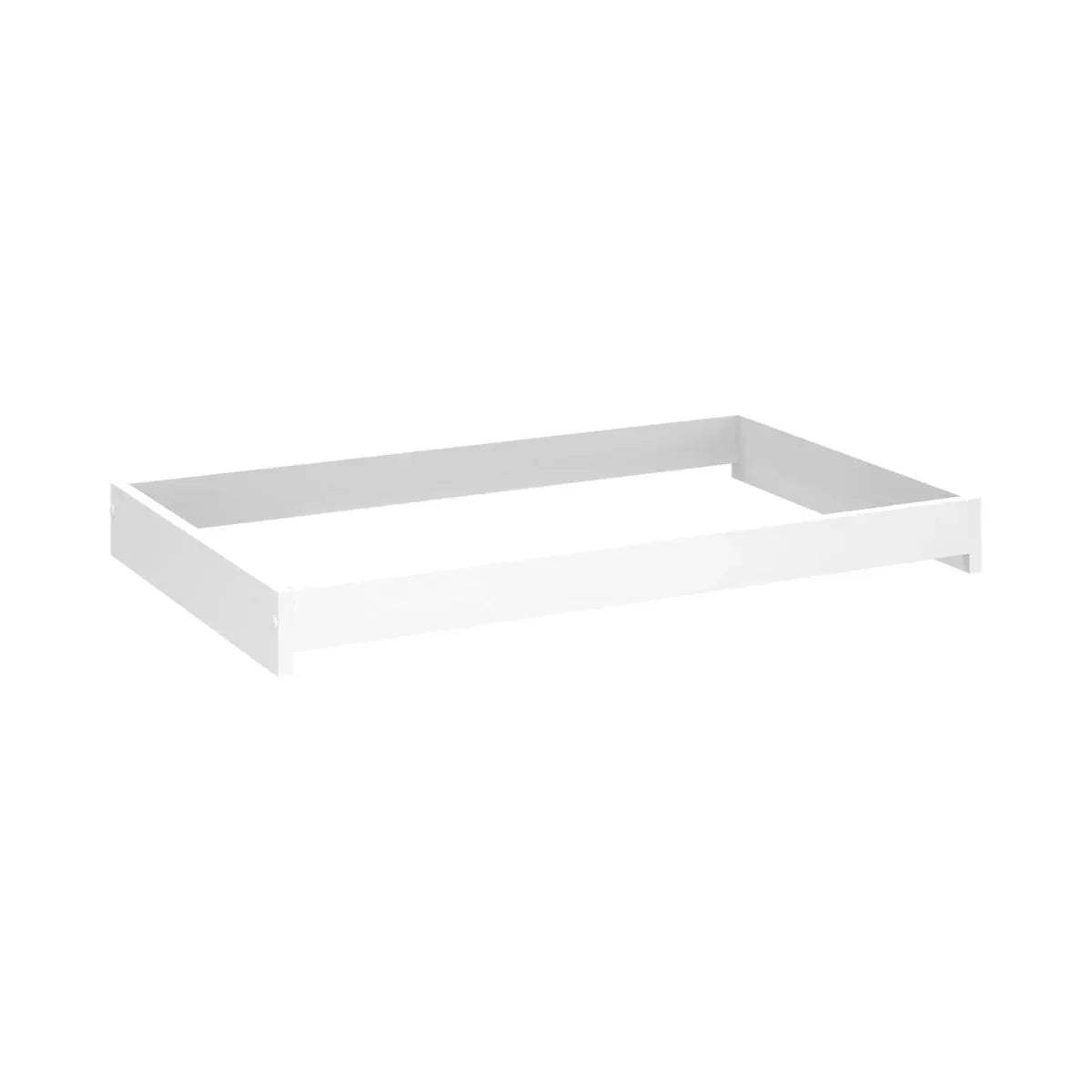 White baby changing unit with raised tray-style top and open interior base