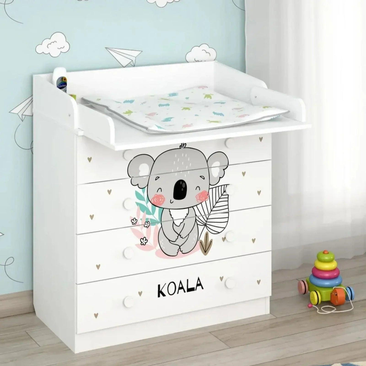 White kids changing dresser with koala artwork, changing pad surface, and drawer knob pulls
