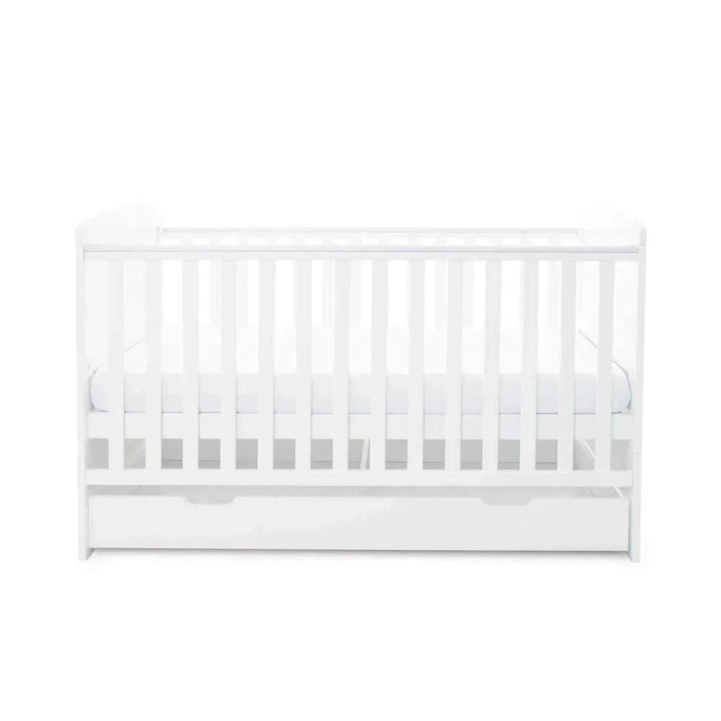 White cot bed side view with slatted rail and drawer base
