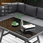 Grey L-shaped sofa with tempered glass dining table and dark tabletop surface