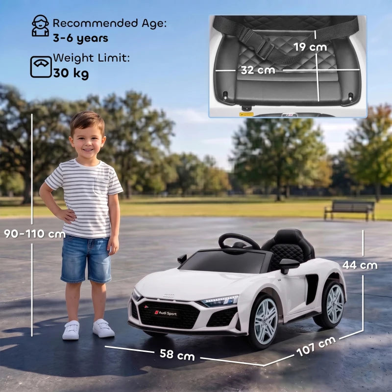 White ride-on car with black wheels shown next to a smiling child outdoors