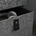 Dark grey fabric drawer front with black handle pull; top seat open