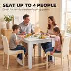 White dining table for up to four people with square tabletop and legs.